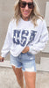 Light grey USA sweatshirt with navy star embroidery and denim shorts.