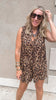 Sleeveless leopard print romper with pleated detail and tie neckline.