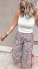 Loose fit leopard track pants with bold red drawstring details.