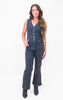 Woman wearing a denim jumpsuit on a white background