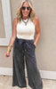 Model wearing faded black lounge pants with a soft, lived-in look and casual fit.