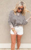 Model wearing MICA white distressed shorts paired with a cheetah sweatshirt 