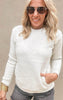 Cozy light beige sweatshirt in soft fleece fabric, paired with dark cutoff shorts for a casual look.