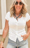 Casual snap-front fitted top paired with classic denim cutoffs for a summer-ready look.