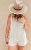 Neutral ribbed romper perfect for warm weather, paired with gold jewelry and boho-inspired accessories.