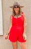Bold red sleeveless knit romper with cinched waist and comfy, casual vibes.