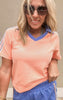 Vibrant orange athletic-style top with bold blue trim