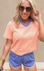 Bright orange top with royal blue detailing for a bold, color-blocked look