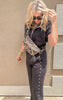 Chic black knit pants with wide leg silhouette and bold stud embellishments.