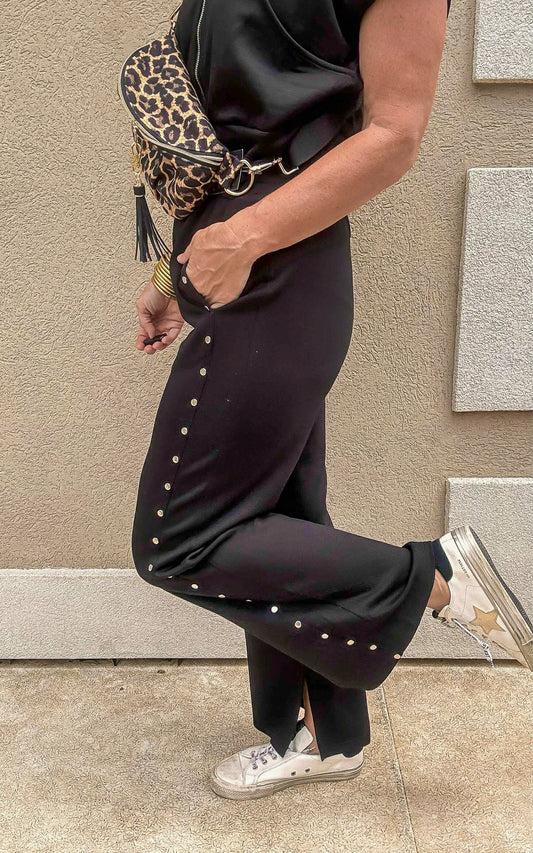 Black high-waisted knit pants with studded detail and flattering wide leg