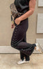 Black high-waisted knit pants with studded detail and flattering wide leg