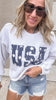 Star print USA graphic sweatshirt with frayed denim shorts outfit.