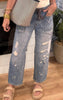 Distressed denim jeans with drawstring waist styled with a classic white tank.