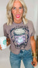 Woman wearing a graphic t-shirt and holding a Starbucks cup.