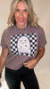 Woman wearing a brown t-shirt with a ghost design on a beige background