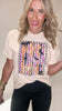 Woman wearing a beige t-shirt with 'Spooky' graphic design on a plain background