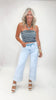 Woman wearing a striped top and light blue jeans on a white background