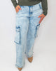 Light blue acid-wash jeans worn by a person on a white background