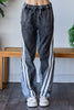 Two tone black and gray oversized denim jeans with contrast side stripe detail.