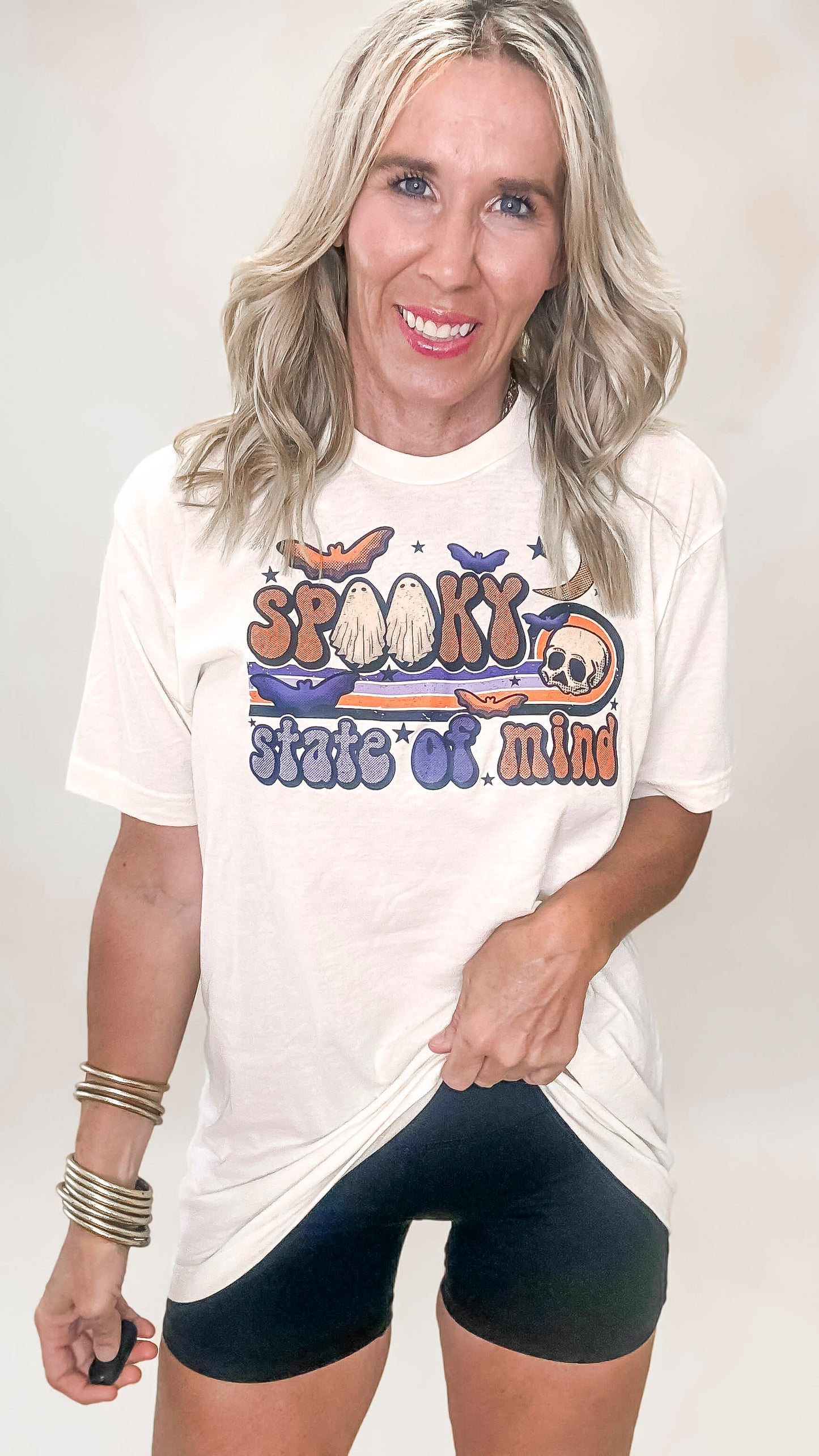 Halloween-themed t-shirt with bold orange and purple design, retro font, and spooky icons.