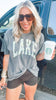 Pepper-washed graphic tee with bold camo 'LAKE' lettering across the front.
