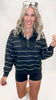 Black quarter zip pullover with thin white stripes and a mock neckline, featuring a relaxed fit and sporty style.
