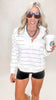 Women's white stripe pullover featuring a quarter zip front, drop shoulders, and modern mock neck.