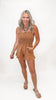 Woman wearing a brown romper on a white background