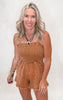 Woman wearing a brown romper against a white background